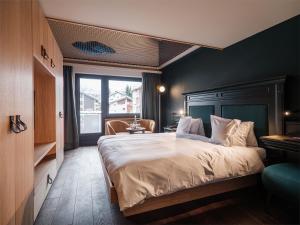 Säng eller sängar i ett rum på Hotel National Zermatt