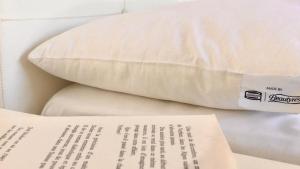a pillow and a piece of paper on a bed at Casa Mafalda B&B in Lipari