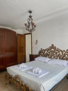 a bedroom with a bed with two towels on it at Monastero del Lago in Viverone