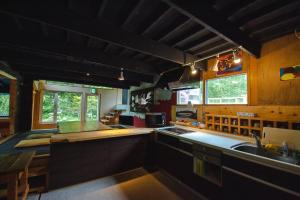 a large kitchen with a sink and a counter at Artemina Bettei in Teshikaga