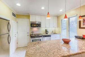 a kitchen with white cabinets and a granite counter top at Silverado Resort and Spa II in Napa