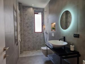 a bathroom with a sink and a toilet and a mirror at Vacation home near the sea in Durrës +13 photos