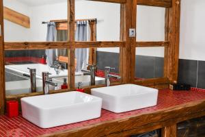 two white sinks on a red counter in a bathroom at Vielyterra - Chalet haut de gamme - Domaine du mont blanc in Saint-Gervais-les-Bains +20 photos