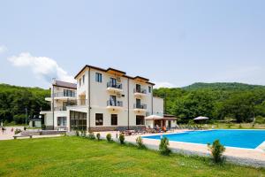 a hotel with a swimming pool and a resort at Sviana Resort in Telavi