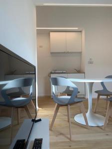 a dining room with a table and two chairs and a table at Residenze Mazzini in Mantova +21 photos