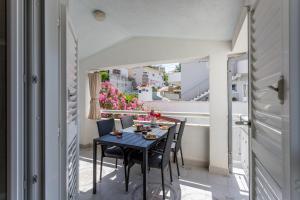 a table and chairs on the balcony of a house at Apartments Drago Kovačić in Omiš