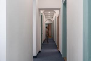 a corridor of an office building with a hallway at Hostel Antique in Pula