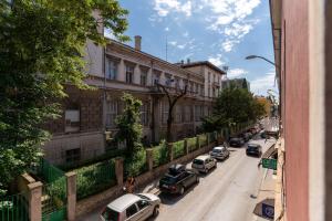 a street with cars parked on the side of a building at Hostel Antique in Pula