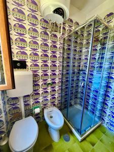 a bathroom with a toilet and a shower at La Vela Apartment in Stintino +23 photos