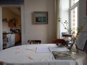 a table in a kitchen with a white table cloth at Agnes Vintage Home in Hannover