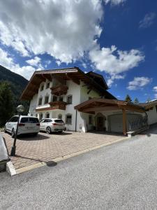 un edificio con coches estacionados en un estacionamiento en Jakob, Landhaus, en Tux