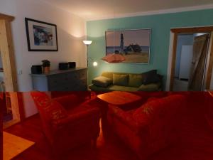 a living room with a couch and a table at Ferienhof - Rauhenberg in Wangels