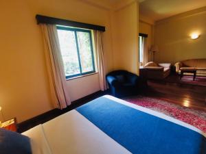 Una cama o camas en una habitación de La Mada Hotel