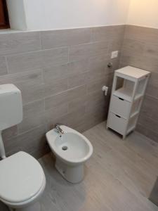 uma casa de banho com um WC branco e um lavatório. em La casa dei nonni em Pantelleria