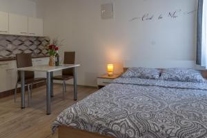 a bedroom with a bed and a table with chairs at Apartmani Kržak in Nin +92 photos