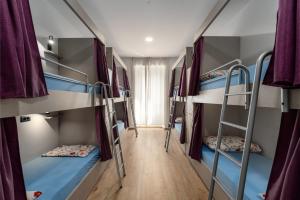 a room with a bunch of bunk beds at Hostel Antique in Pula