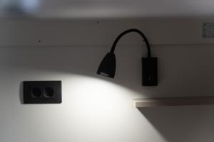 a light on a wall in a room at Hostel Antique in Pula