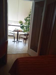 a view of a room with a table and a chair at Hotel Galaxy in Loutra Edipsou