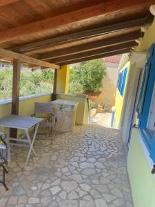a patio with a table and chairs on a house at Pjacal in Veli Lošinj