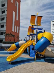 a playground with a slide in a park at Preferred30 3R2B 7pax Meritus Perai in Perai