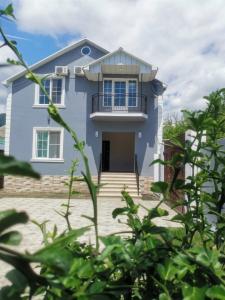 a blue house with stairs in front of it at Golden House in Gabala