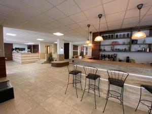 a lobby with chairs and a bar in a building at Solaris Hotel in Balatonföldvár
