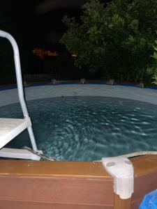 a swimming pool at night with a chair in it at Casa da Vila in Penamacor