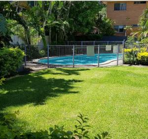 a fence around a swimming pool in a yard at Villas Sienna Homestay in Gold Coast