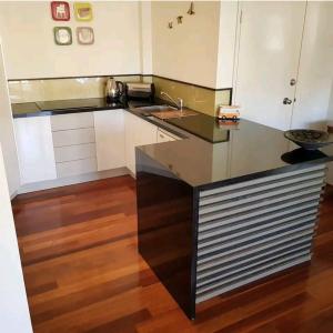 a kitchen with a sink and a counter top at Villas Sienna Homestay in Gold Coast
