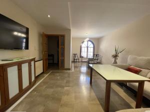 a living room with a couch and a table at Casa Gallito, By DaiMar in Granada