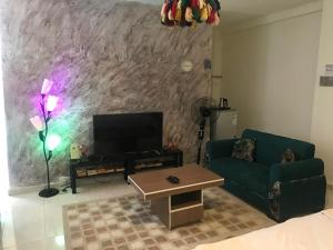 a living room with a couch and a tv at La Bella BedoUina in Wadi Musa