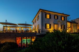 a house with lights on in front of it at Roccafiore Spa & Resort in Todi