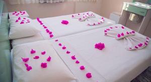 a hospital bed with pink flowers on it at Özay Apart Otel in Muğla