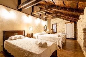 Duas camas num quarto grande com tectos em madeira em Villa Castello em Ágios Nikólaos