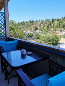 a table and chairs on a balcony with a view at IRIS STUDIOS in Agios Nikitas