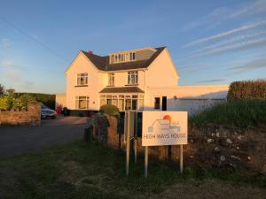 a house with a high winds house sign in front of it at High Ways House in Woolacombe