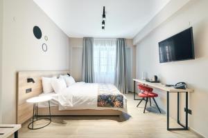 Postel nebo postele na pokoji v ubytování The Mavili urban stay