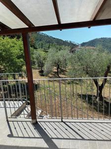 a balcony with a view of a field and trees at CASA GIANNI citra 011008 LT 0014 in Pegui