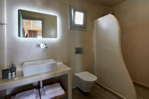 カマリにあるアクロポール サンライズのバスルーム(洗面台、トイレ、鏡付)