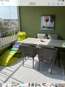 a table and chairs in a room with a balcony at Sole in Makarska