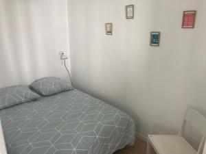 a bedroom with a bed and pictures on the wall at Studio indépendant 30m2 4 pers chez l'habitant Quartier des Roses in Les Sables-d'Olonne