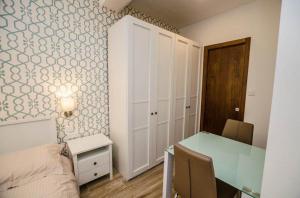 a bedroom with a desk and a bed and a table at Valletta Republic Suite in Valletta