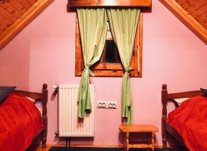 a bedroom with two beds and a window at Grand Rabbit House on the Hillock in Žabljak