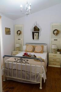 a bedroom with a bed and two dressers and a mirror at Eleonas-Olive grove traditional holiday appartment in Sgourádes