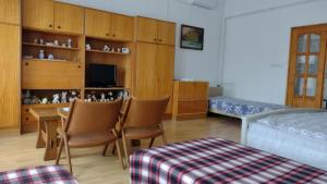 a bedroom with a bed and a table and chairs at Dráva Völgye Vendégház in Zákány