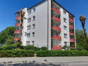 a white apartment building with red balconies at Mokka Apartament in Kielce