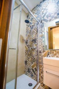 a bathroom with a shower and a sink at Valletta Republic Suite in Valletta