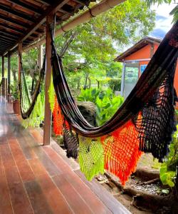 a hammock hanging from a building in a garden at Casa Da Didda in Fernando de Noronha