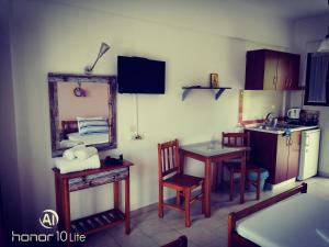 a small kitchen with a table and a mirror at Avra Ηouse in Kriopigi