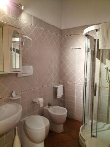 a bathroom with a toilet and a sink and a shower at Night & Day Affittacamere di Laura Patuelli in Cotignola +128 photos